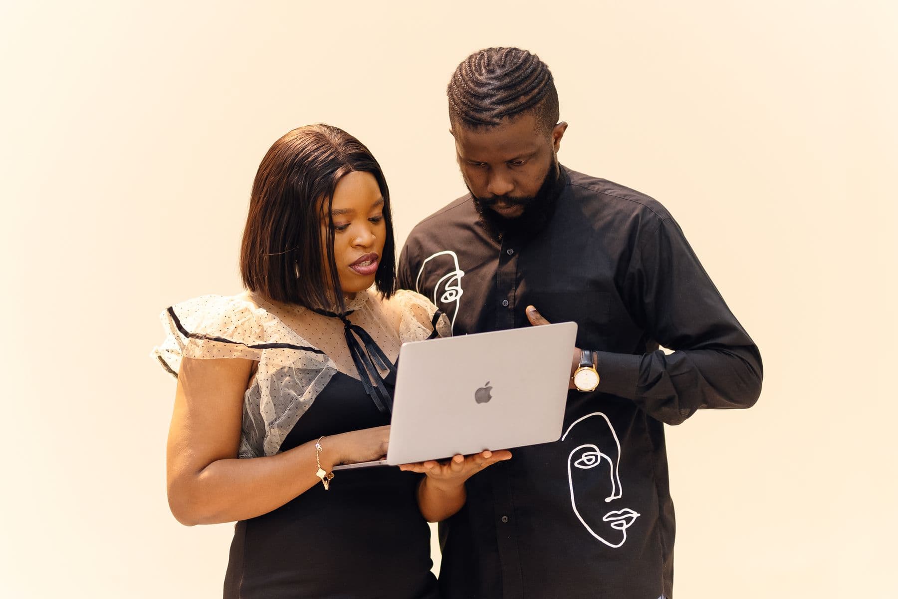 Two professionals collaborating on a laptop